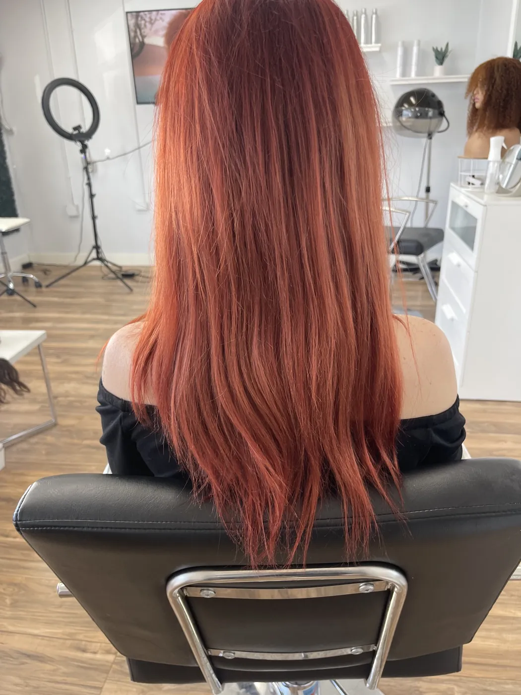 Long red tape-in extensions from behind